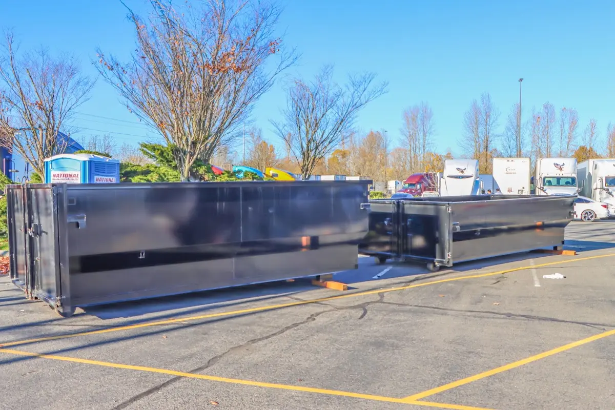 Professional dumpster rental service with roll-off container on residential driveway in New Garden